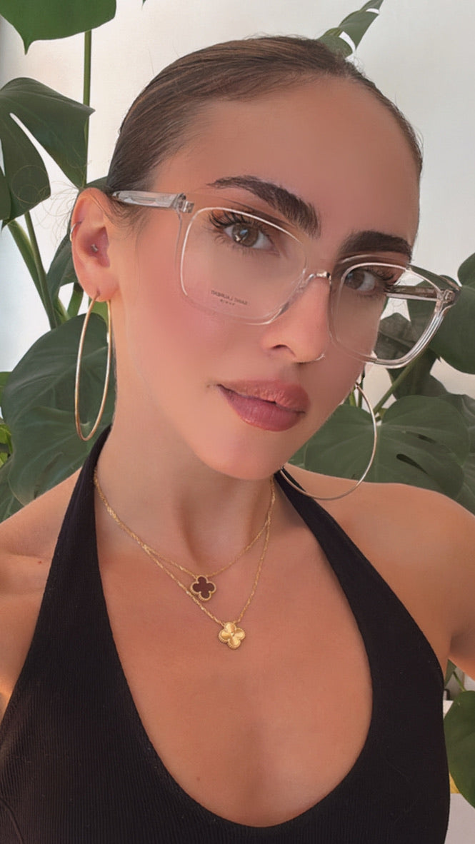 Clear rectangular eyeglass frames on model, slim metal temples, translucent finish