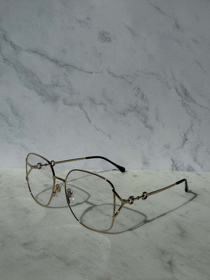 Gold oversized horsebit eyeglass frames with horsebit bridge and black temple tips