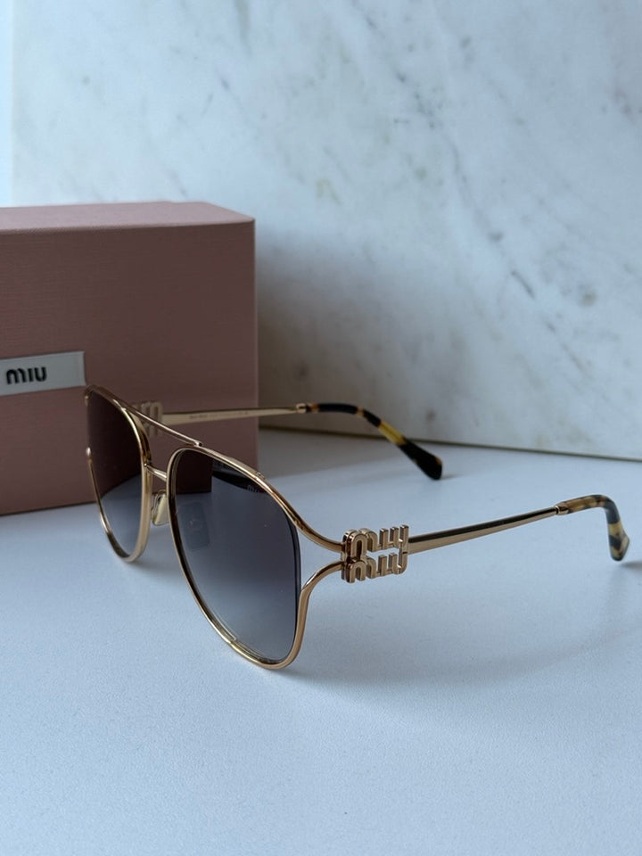 Miu Miu gold aviator sunglasses with dark lenses and decorative bow on temple
