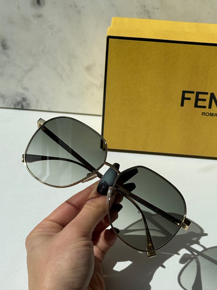Fendi gold-tone metal round sunglasses with dark green tinted lenses and hinge detail