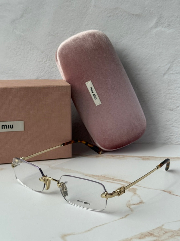 Miu Miu rimless eyeglass frames with gold detailing and clear lenses, angled side