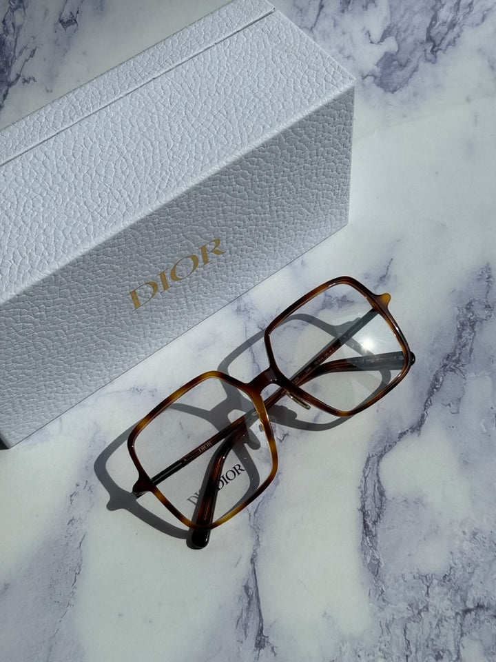 Havana brown square eyeglasses with Dior logo on temple beside white box