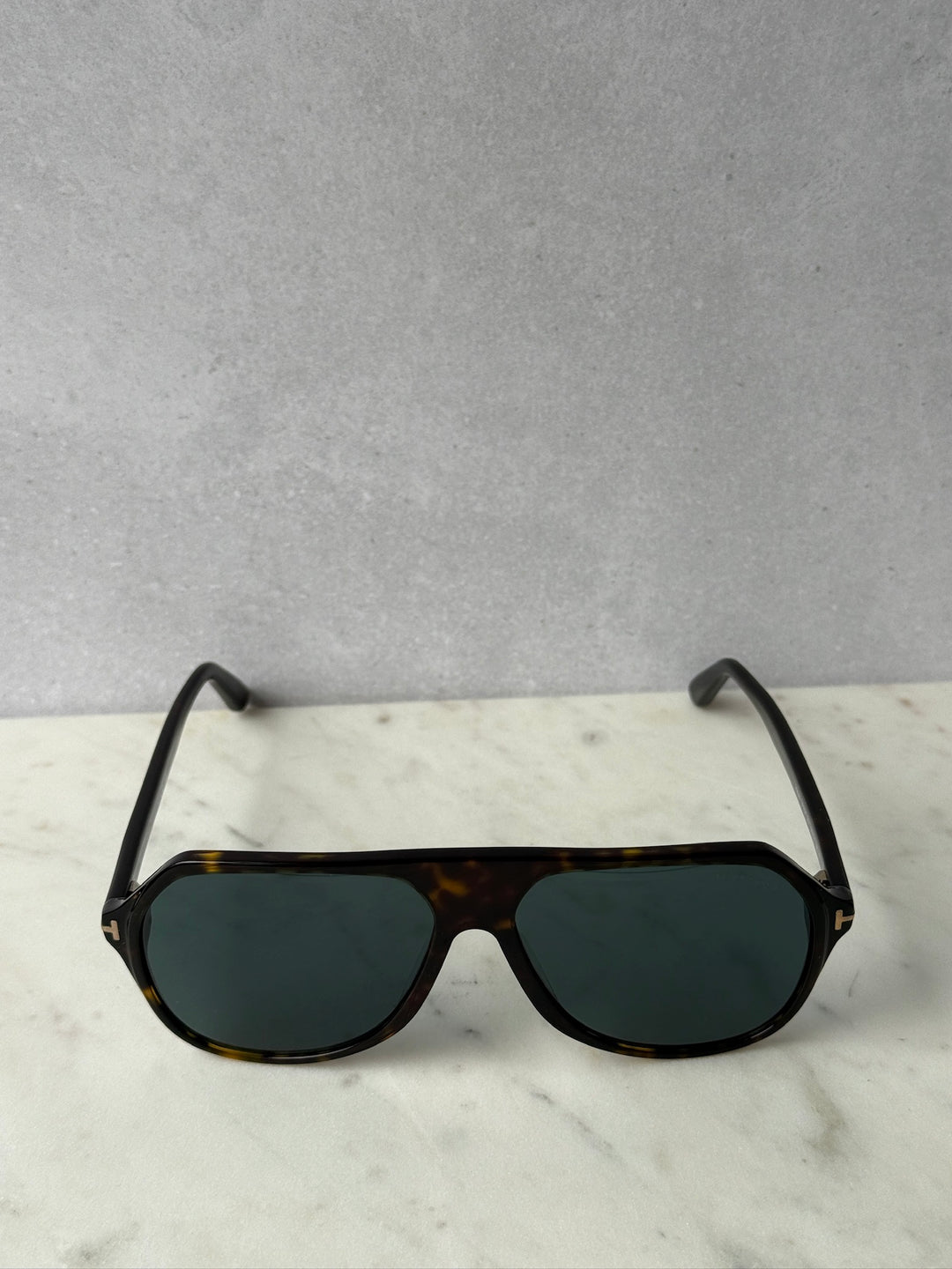 Aviator sunglasses with dark Havana frame and green tinted lenses, top view
