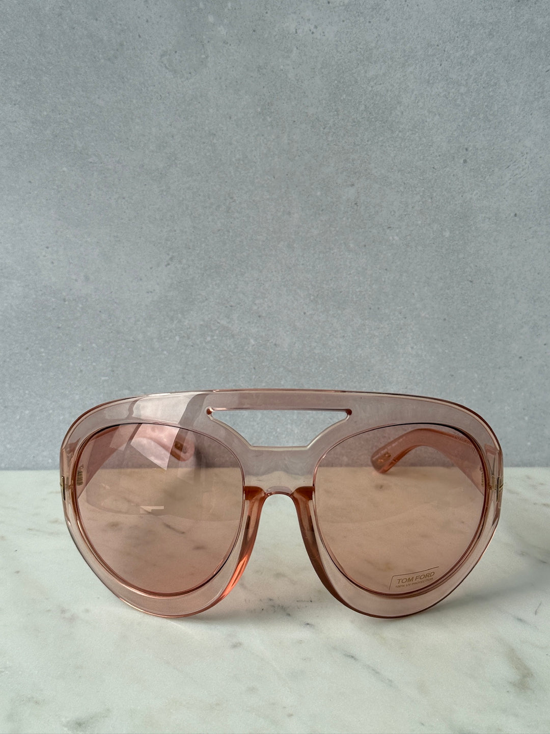 Oversized pink mask sunglasses with wide lenses and gold-tone nose bridge