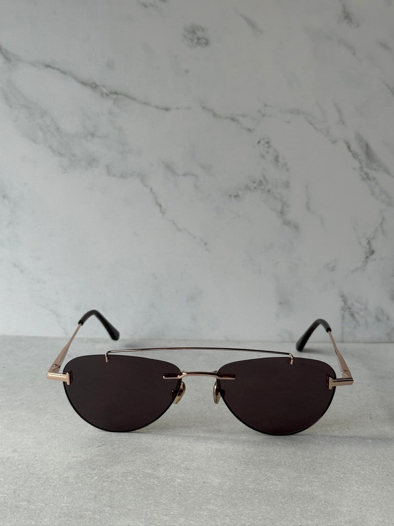 Rose gold aviator sunglasses with dark lenses and slim metal frame, front view