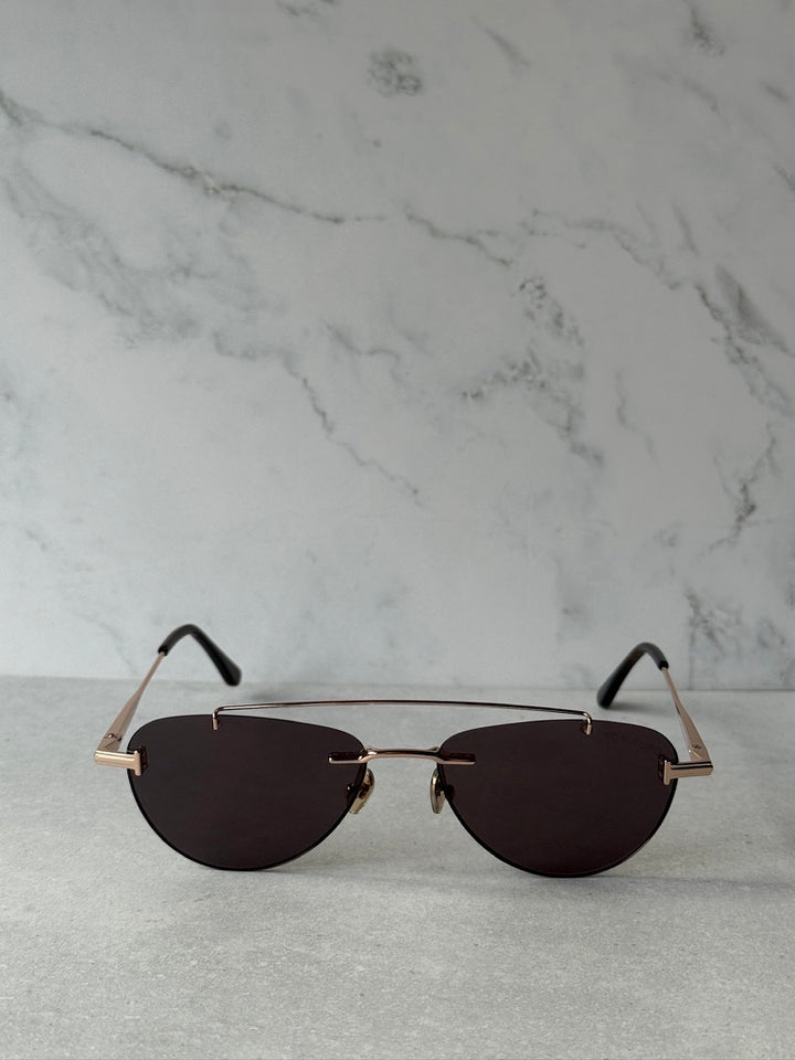 Rose gold aviator sunglasses with dark lenses and slim metal frame, front view
