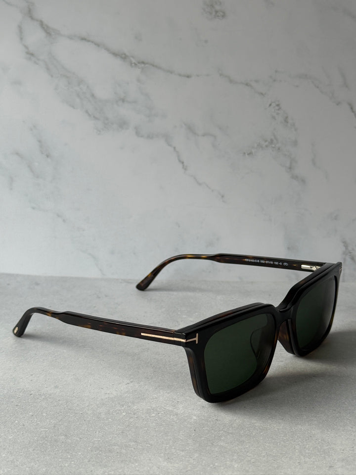 Diagonal view of rectangular sunglasses with dark frame and dark green lenses