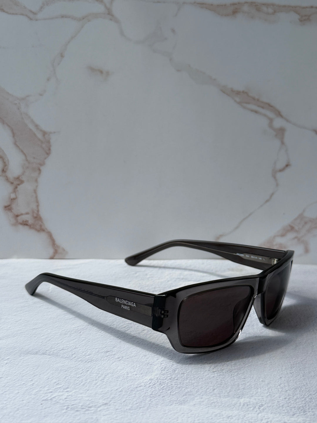 Balenciaga dark grey rectangular sunglasses with dark lenses and logo temple