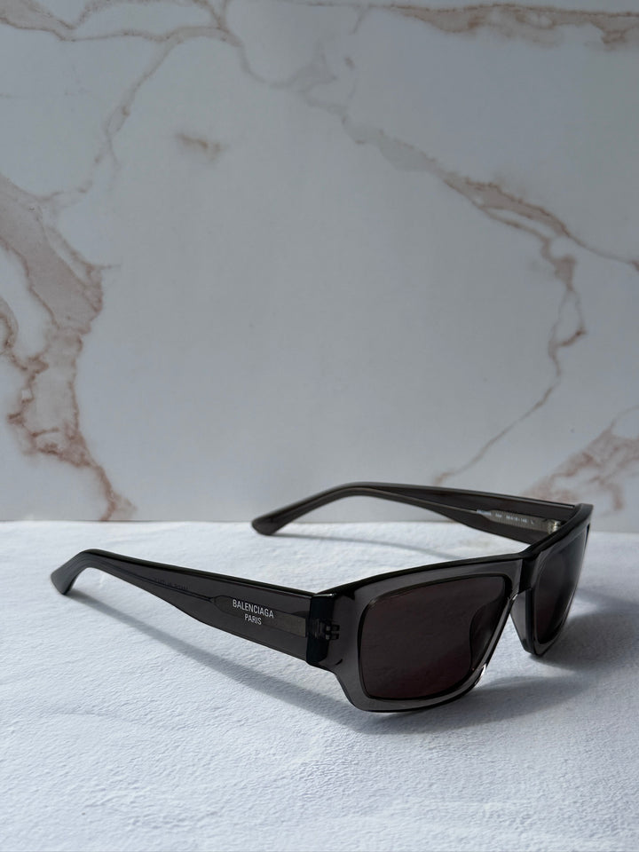 Balenciaga dark grey rectangular sunglasses with dark lenses and logo temple