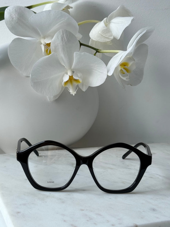 Black curvy eyeglass frames with round lenses and gold Loewe logo, front view
