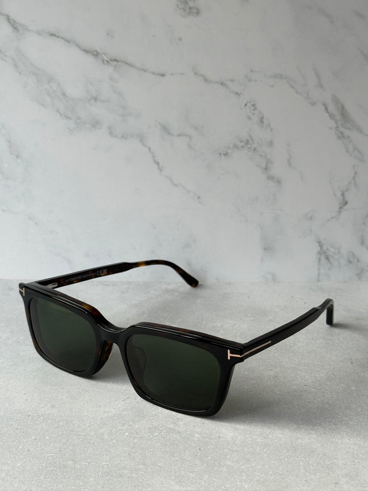 Side view of rectangular sunglasses with dark havana frame and dark green lenses