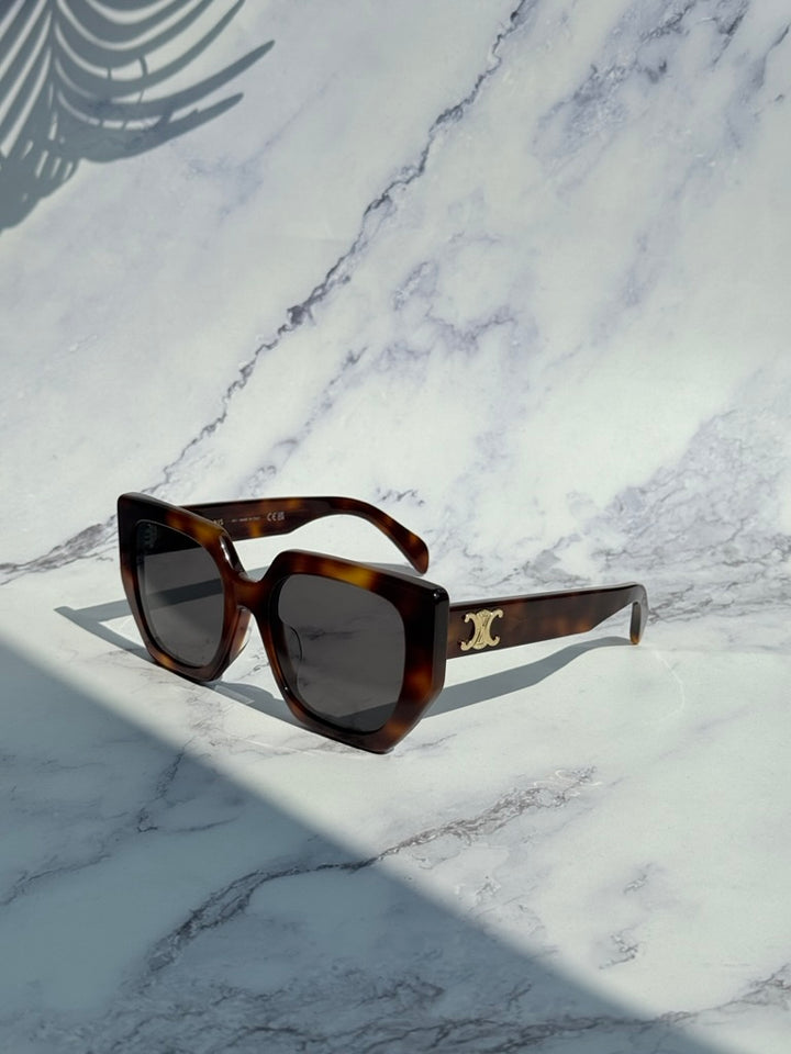 Square cat-eye sunglasses in brown tortoise with dark lenses and gold Triomphe logo