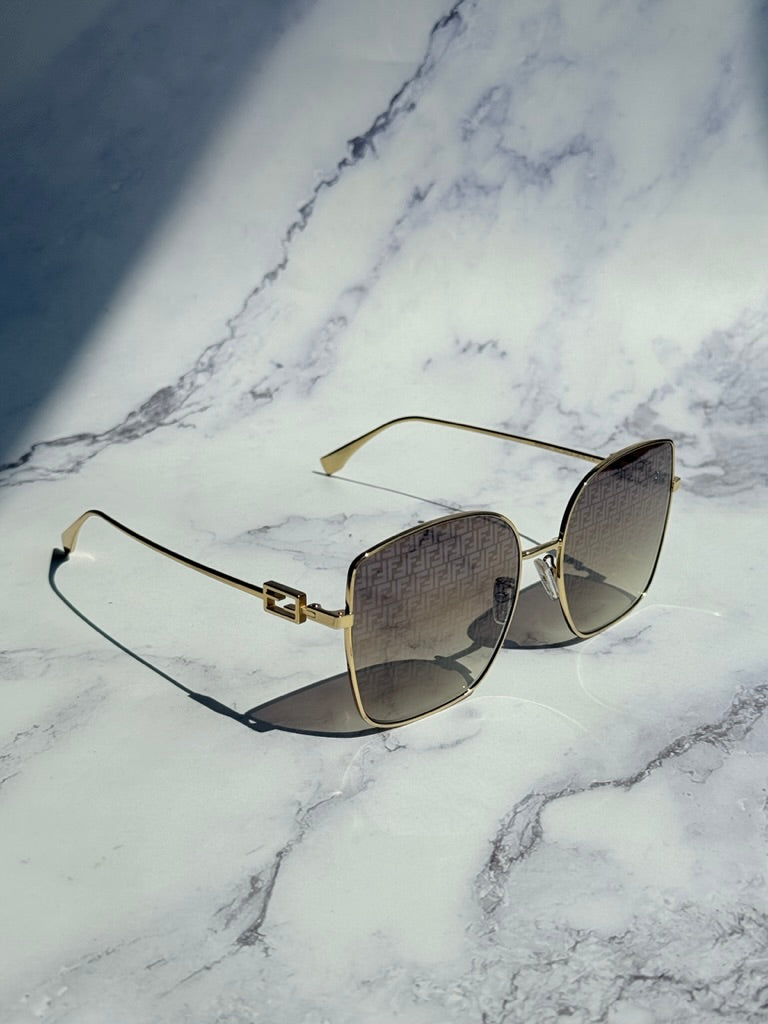 Fendi gold monogram mirror sunglasses, angled side view with square cat-eye mirrored lenses