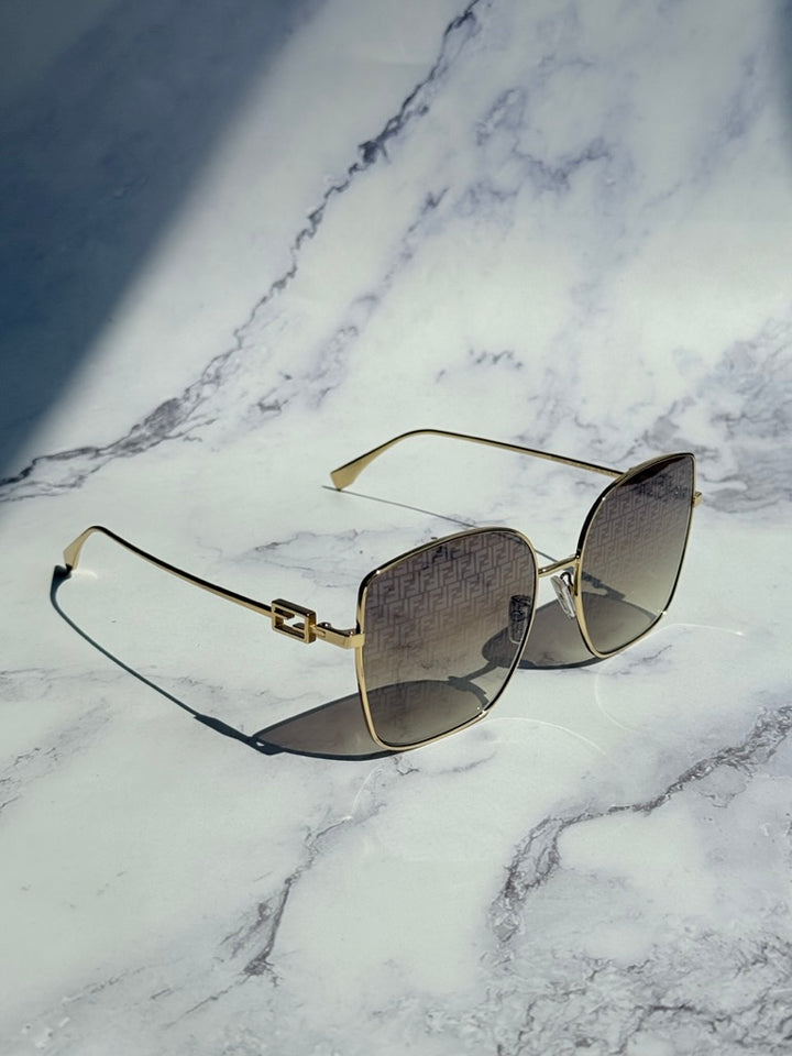 Fendi gold monogram mirror sunglasses, angled side view with square cat-eye mirrored lenses