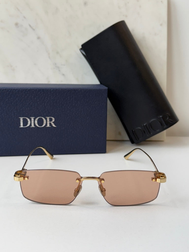 Dior rimless sunglasses front view, tinted pink lenses and gold-tone frame