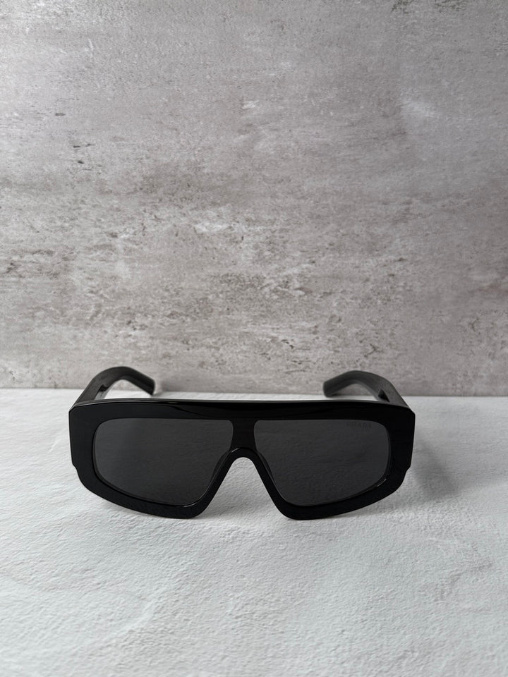 Black PRADA sunglasses with dark lenses and wide squared frame