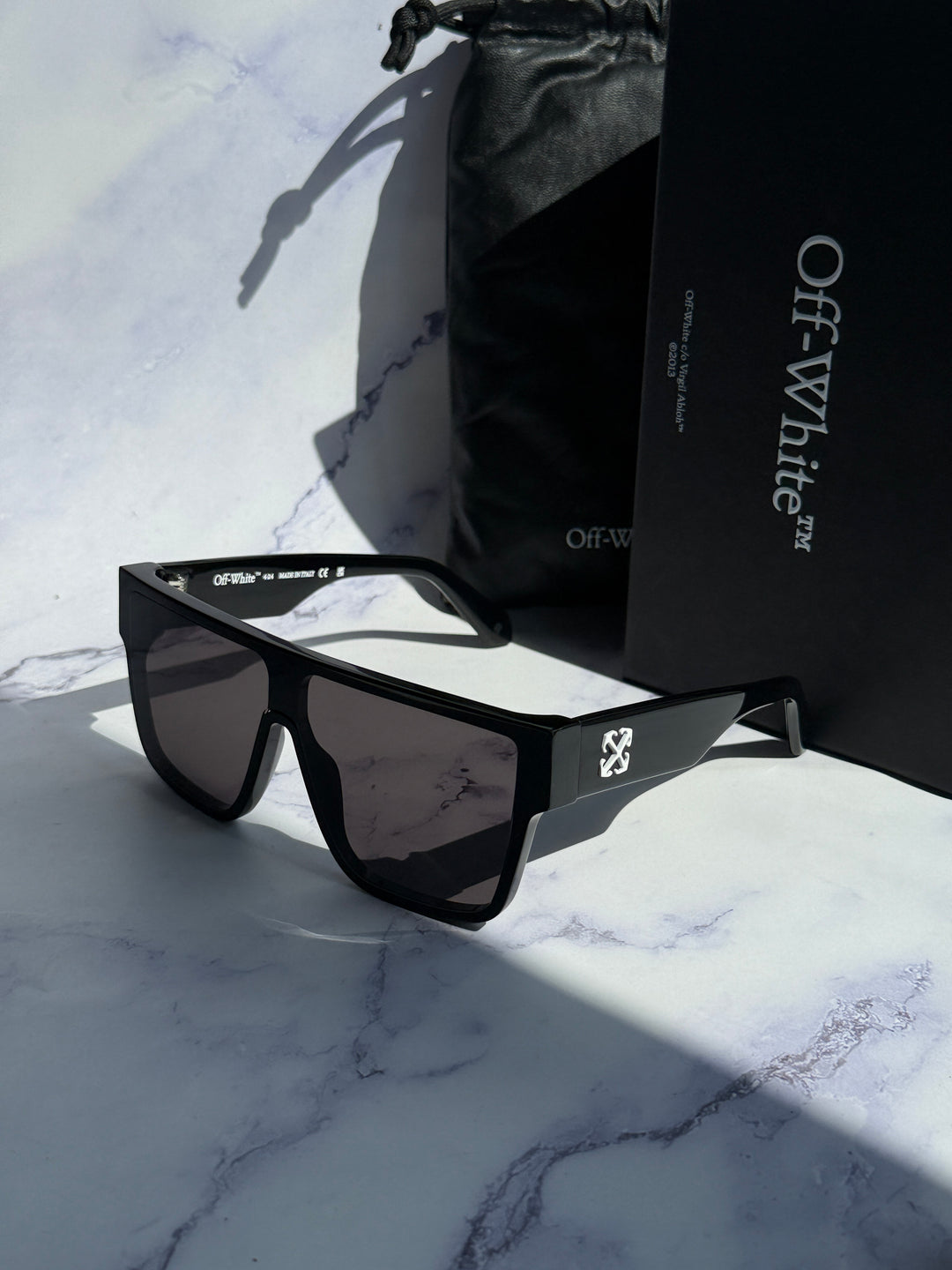 Black square sunglasses with dark lenses and case, logo on temple