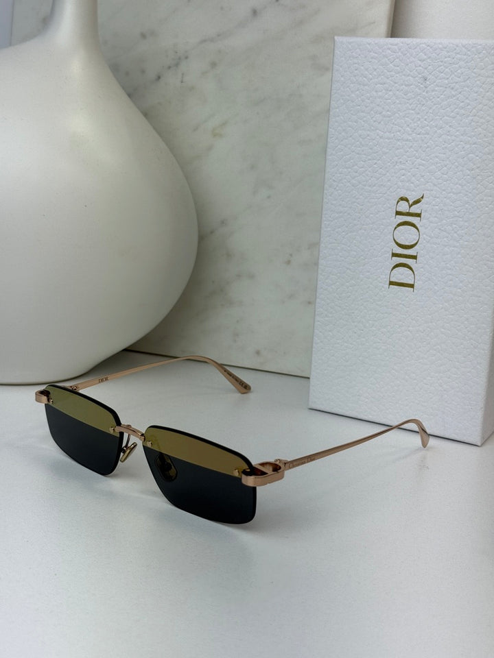Rimless sunglasses with dark rectangular lenses and slim gold-tone bridge