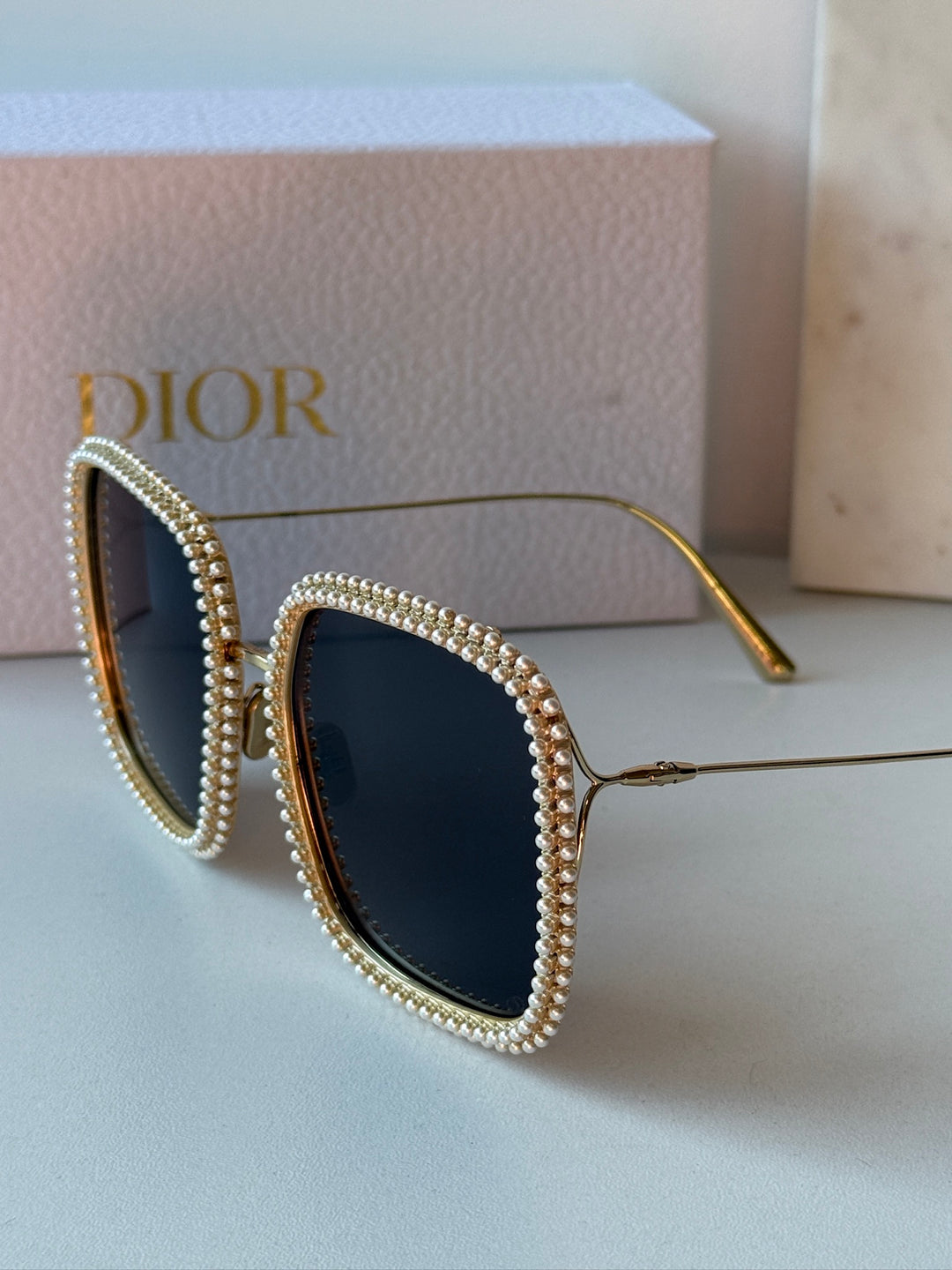 Gold pearl rhinestone cat-eye sunglasses with dark lenses and thin metal arms