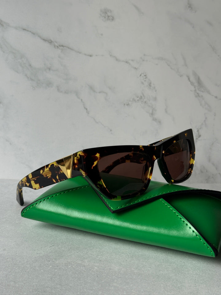 BV1177S cat-eye sunglasses on green leather case, tortoise frame and dark lenses