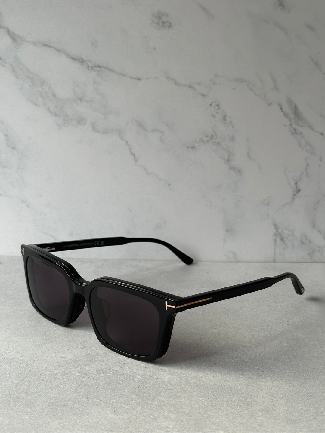 Black rectangular sunglasses side view with dark lenses and slim arms