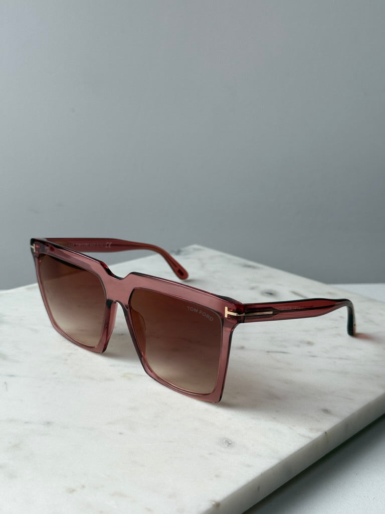 Pink square sunglasses with brown gradient lenses, angled side view