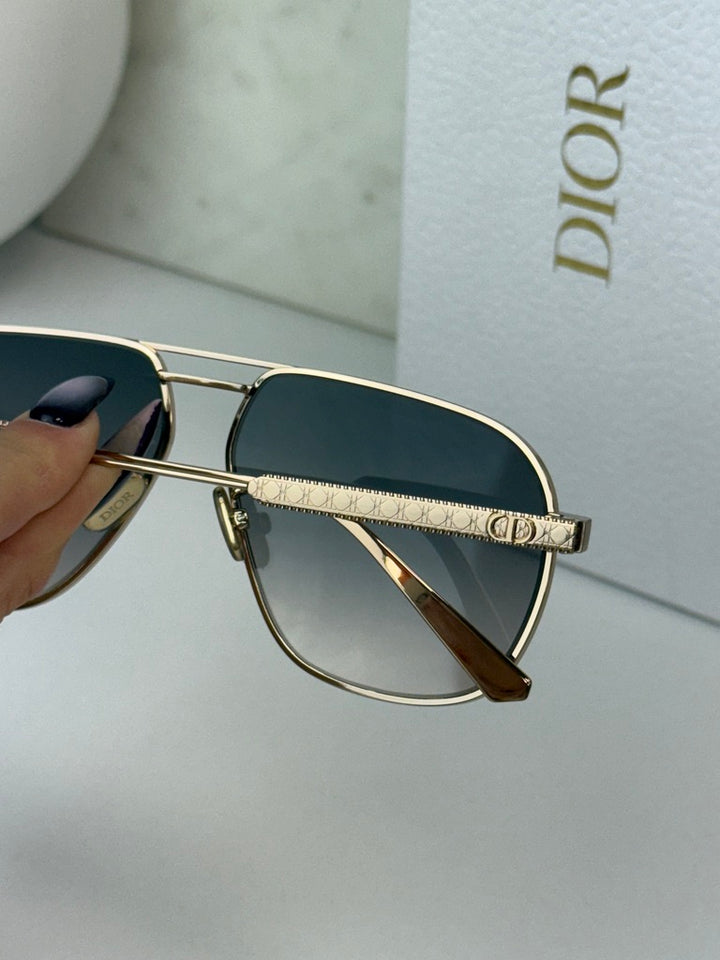 Dior aviator sunglasses with dark lenses and rose gold metal bridge and temple detail