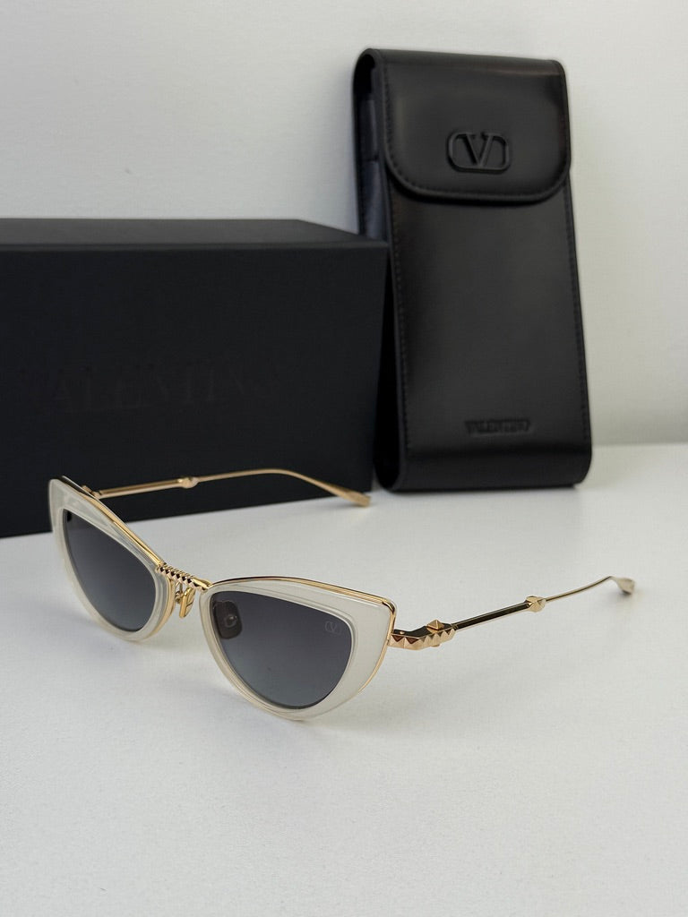 White cat-eye sunglasses with gold-tone frame, dark lenses, plus black case
