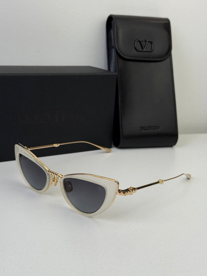 White cat-eye sunglasses with gold-tone frame, dark lenses, plus black case