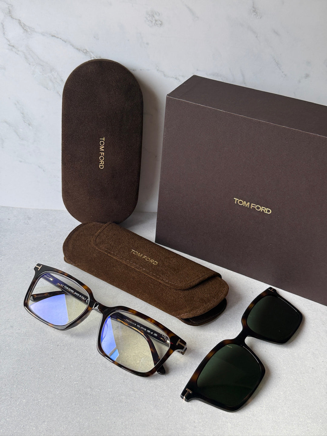Set includes dark havana rectangular frames, clip-on sunglasses, and brown case