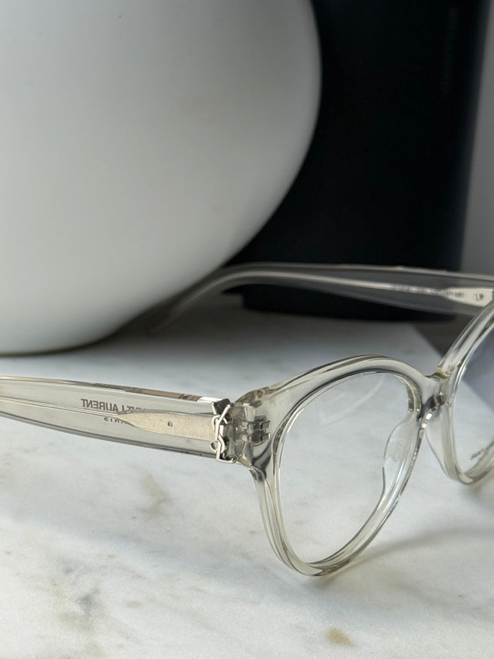Saint Laurent clear eyeglass frames, close-up of temple with engraved text