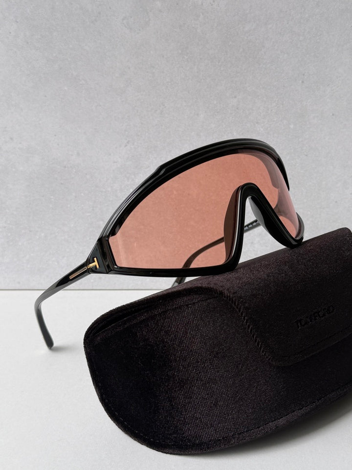 Black sunglasses with orange-tinted lenses, side view with zip fabric carrying case
