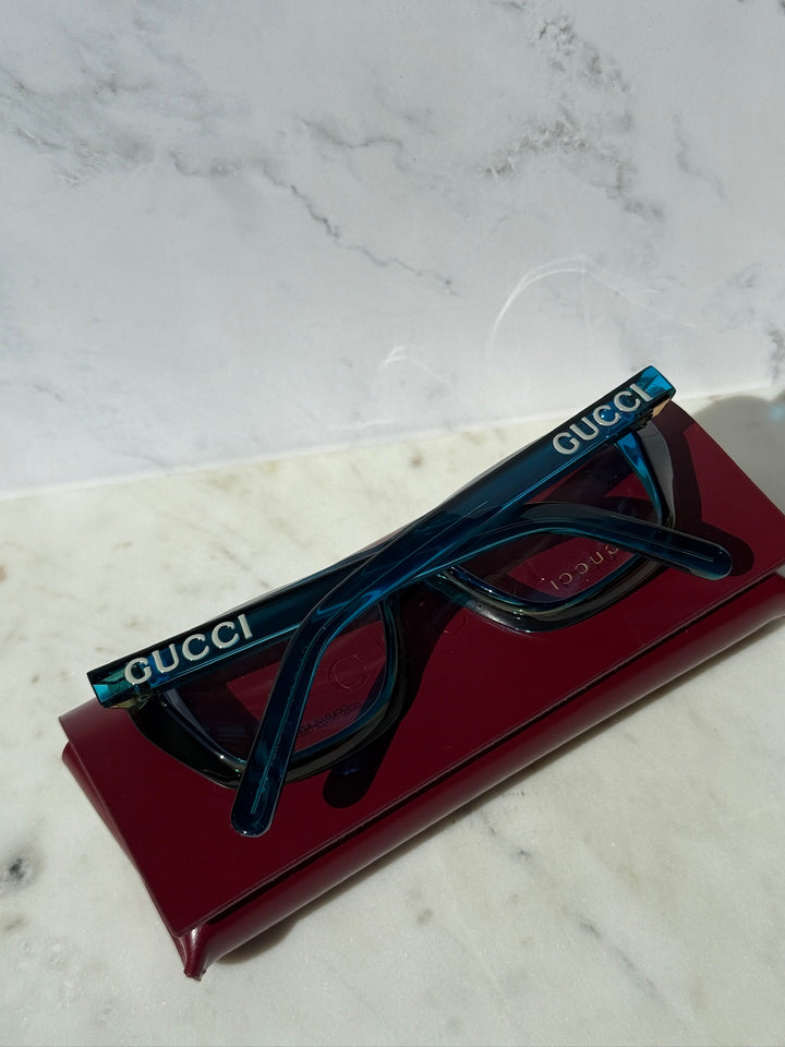Blue Gucci eyeglasses frames, rectangular clear lenses, branded temple side.