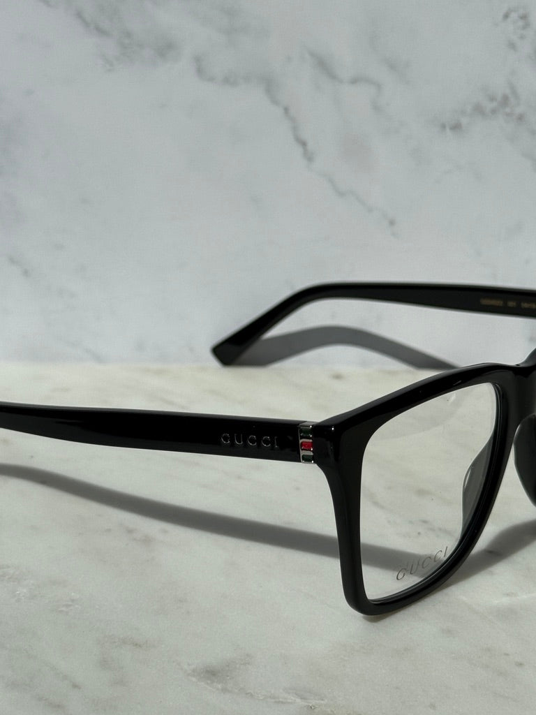 Black rectangular eyeglass frame with Gucci logo detail on hinge and temples