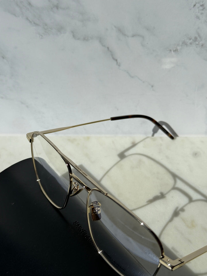 Gold aviator eyeglass frames with clear lenses and detailed metal hinge arms.