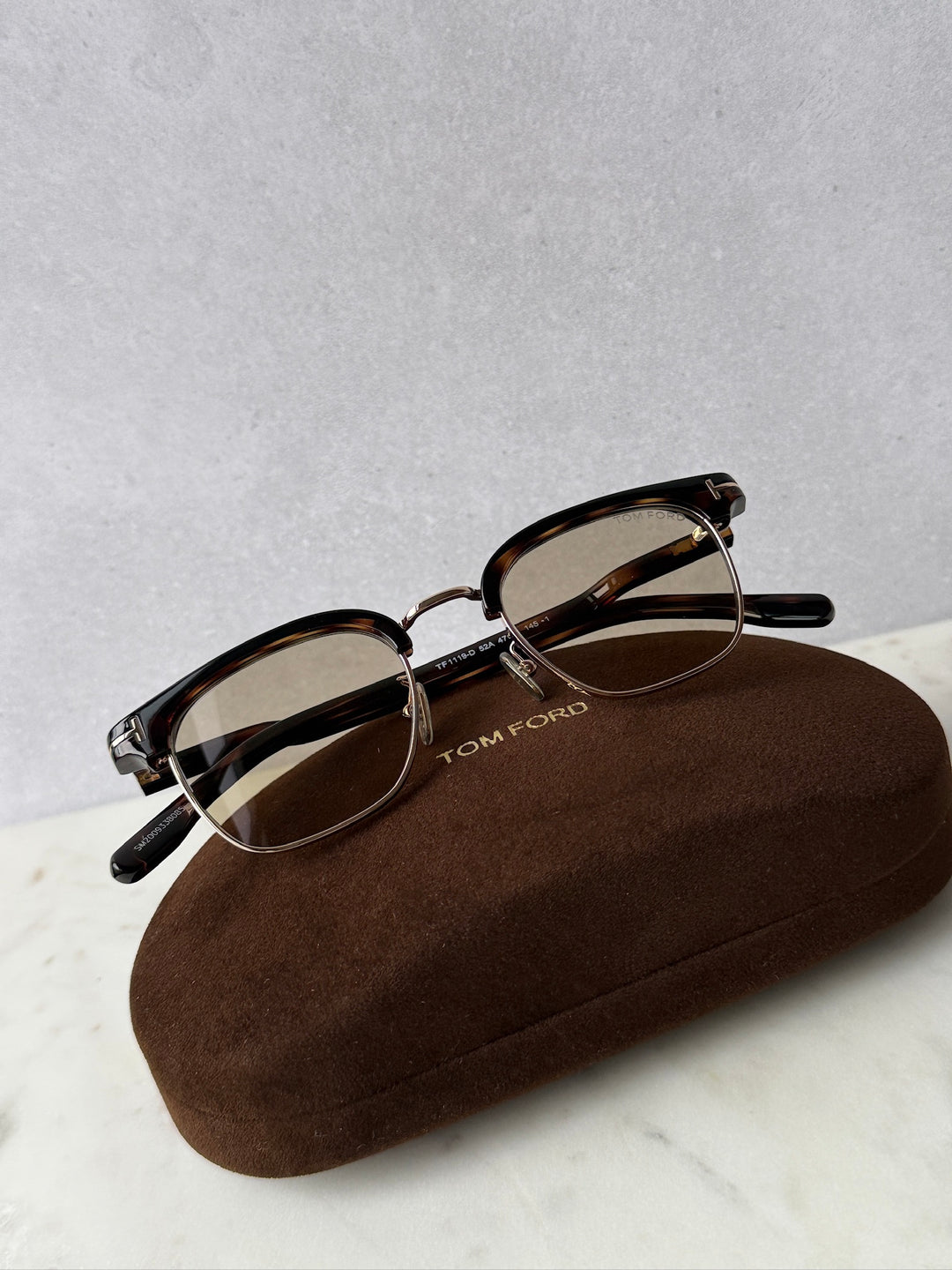 Dark Havana brown sunglasses with brown tinted lenses and gold accents, with soft case