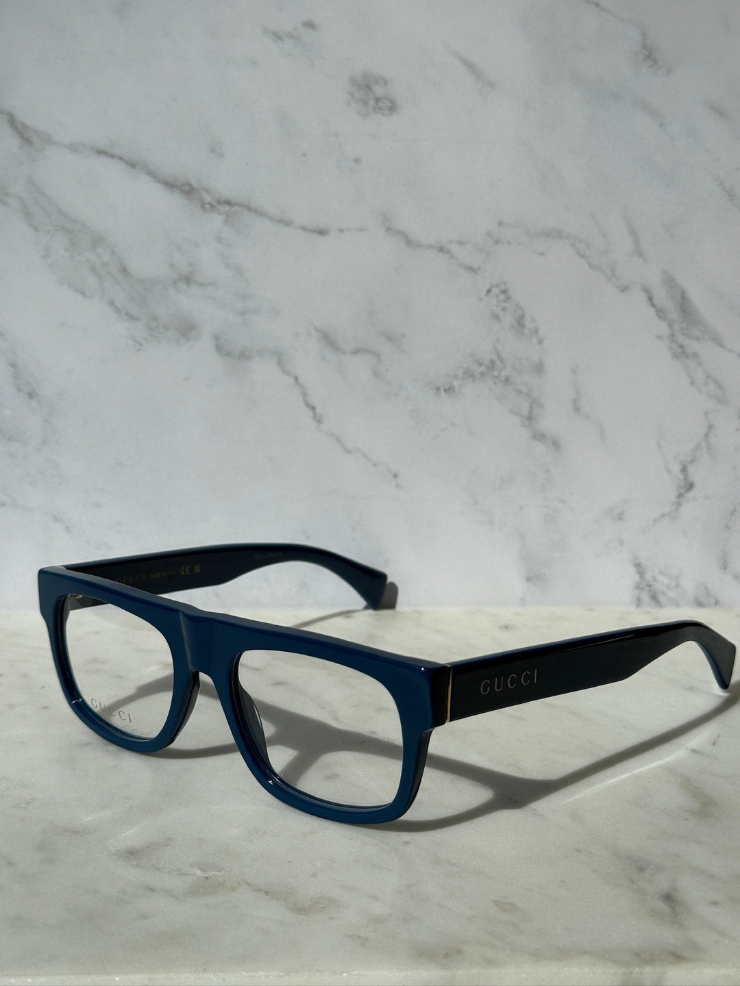 Gucci blue rectangular eyeglass frames with clear lenses and GUCCI branding
