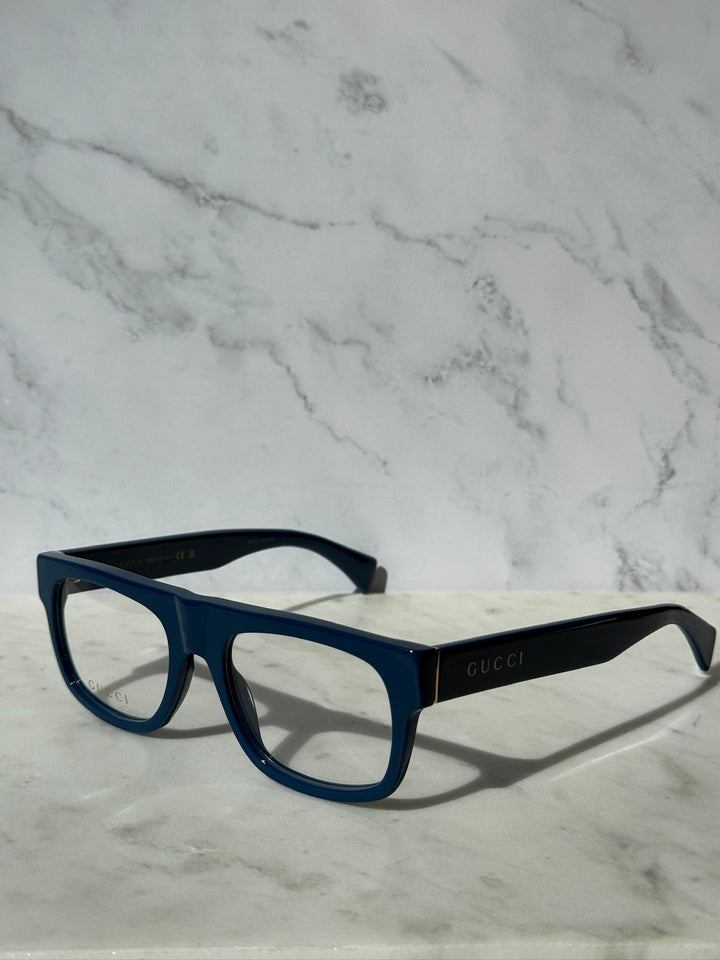 Gucci blue rectangular eyeglass frames with clear lenses and GUCCI branding