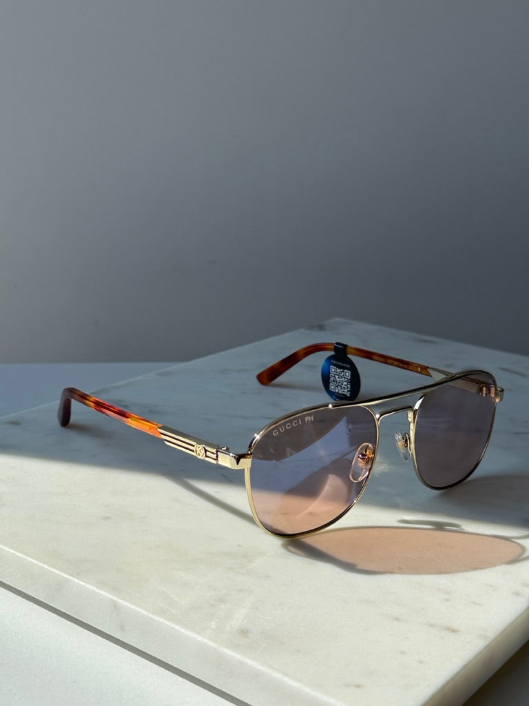 Gucci gold pilot sunglasses with photochromic lenses and tortoise temple tips