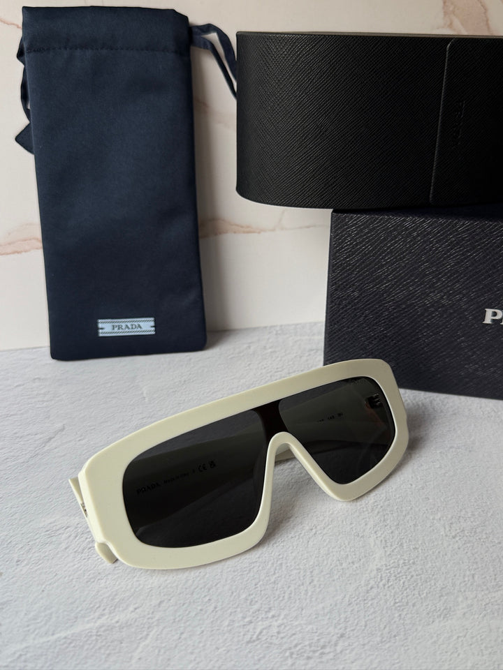 White mask-style sunglasses with black lenses, angled front view