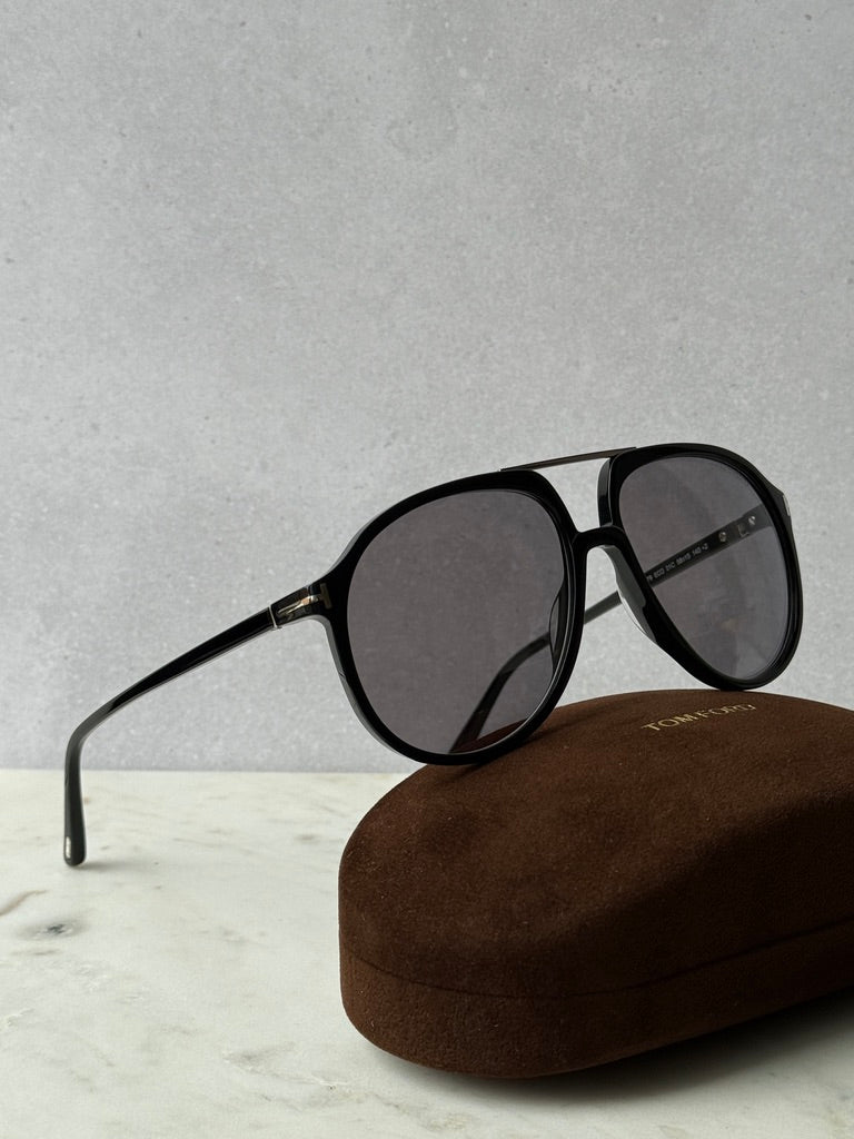 Black oversized aviator sunglasses, side view, with brown case
