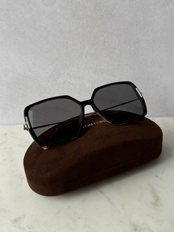 Black polarized sunglasses with square dark lenses and gold-tone temple accents