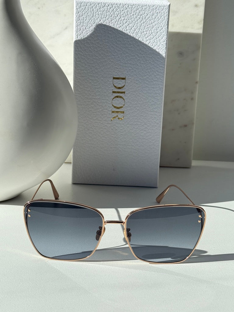Dior gold-tone square sunglasses with blue-grey gradient lenses, front view