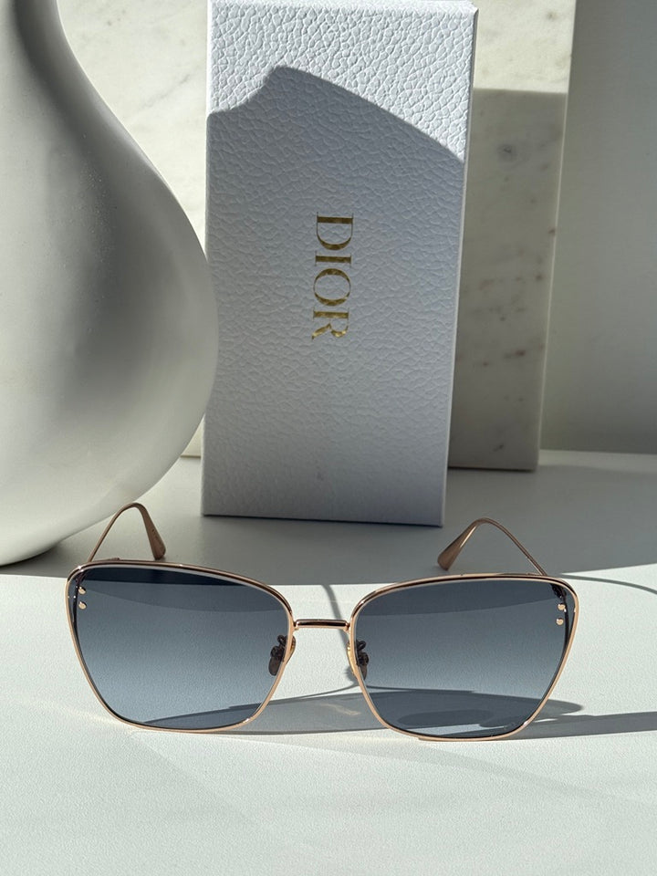 Dior gold-tone square sunglasses with blue-grey gradient lenses, front view