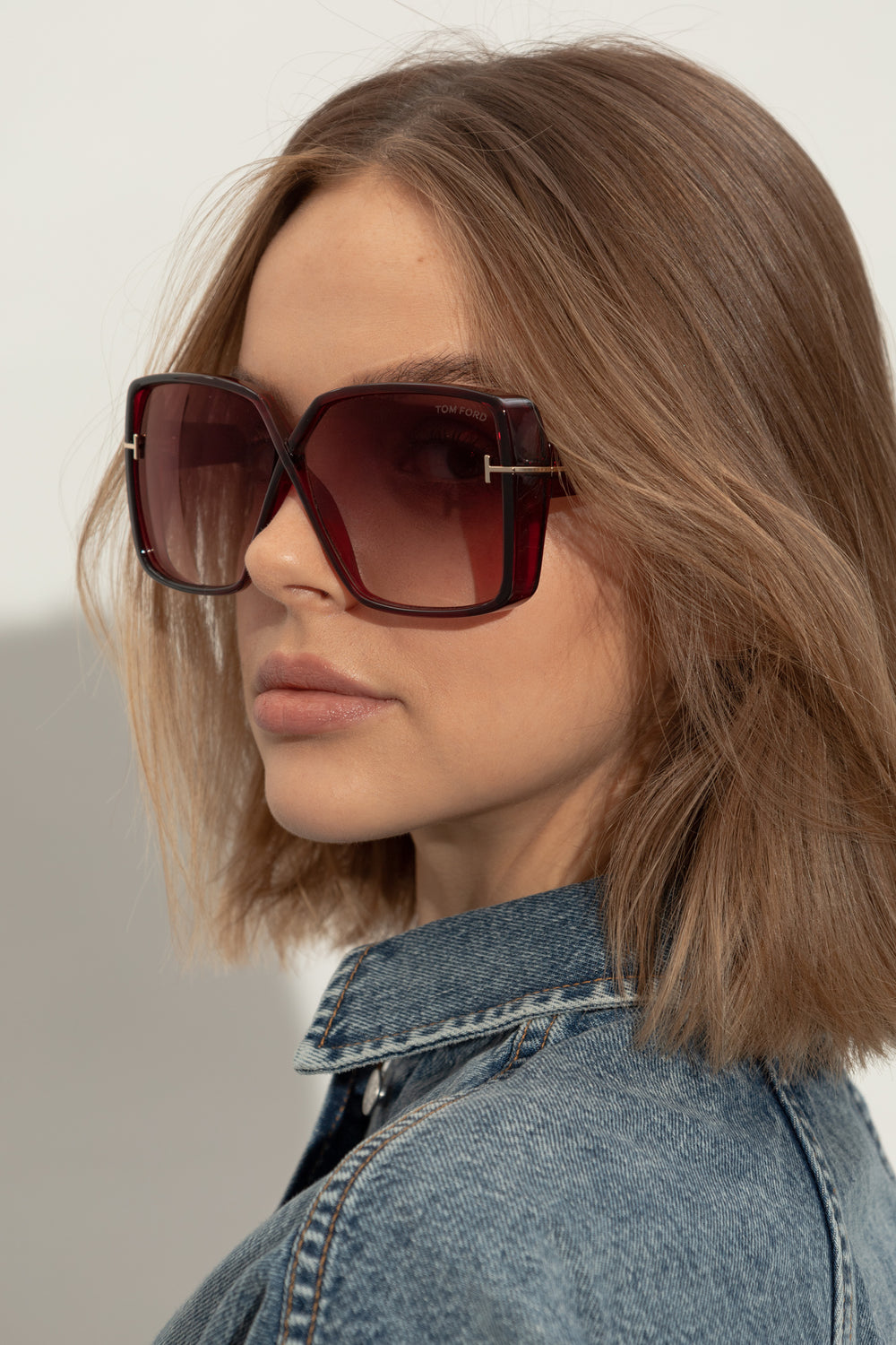 Square burgundy sunglasses with tinted gradient lenses and gold-tone bridge detail