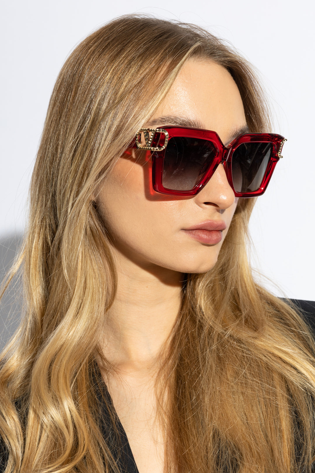 Valentino red oversized crystal sunglasses on model with dark lenses