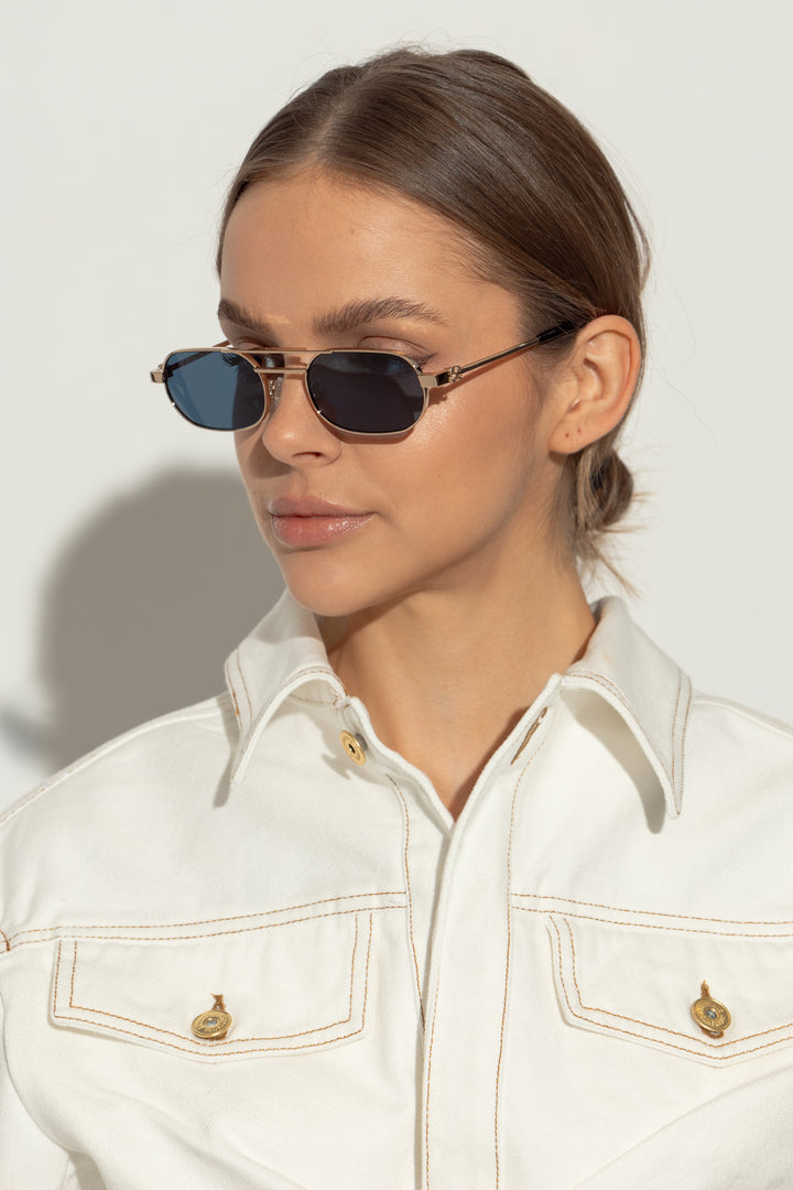 Aviator sunglasses on model: silver frame with dark blue lenses and slim black temples