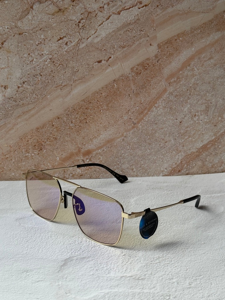 Gucci gold metal pilot sunglasses with photochromic lenses and black temple accents