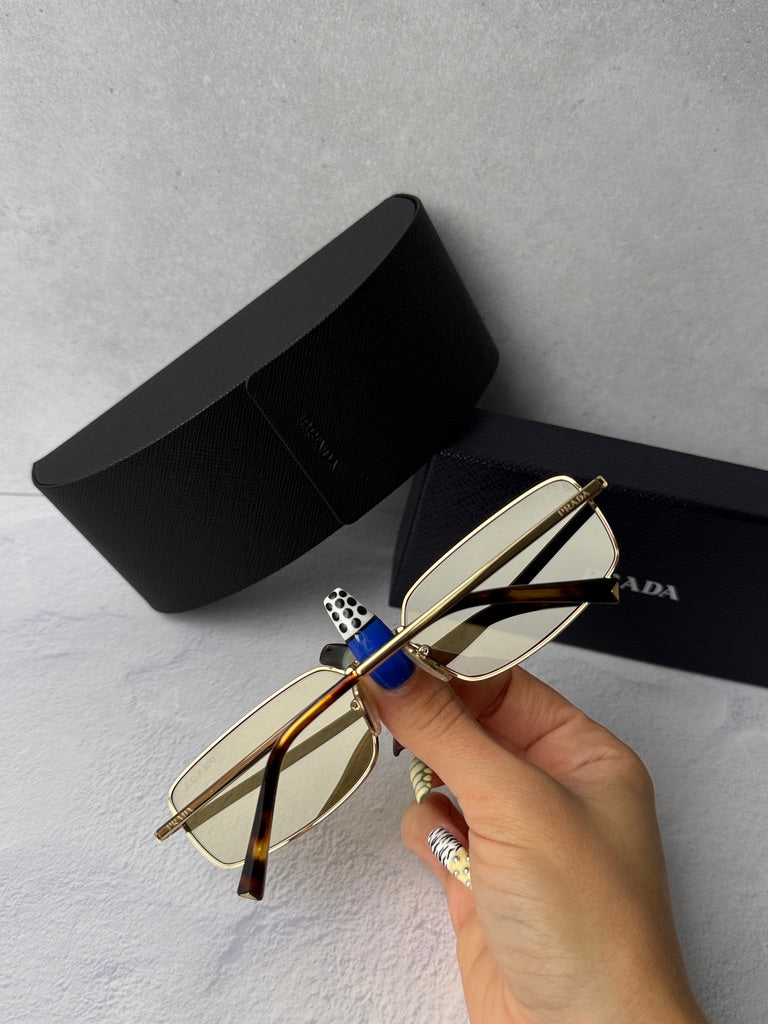 Gold metal rectangular sunglasses with brown-tinted lenses and black case.