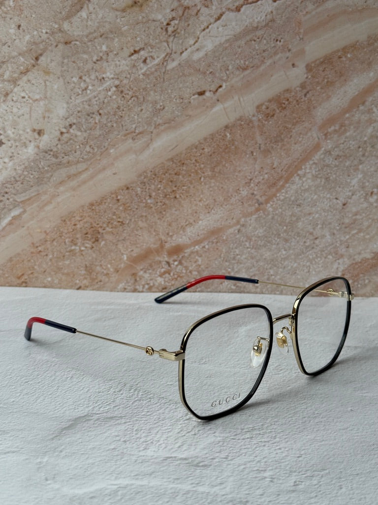 Gucci square eyeglasses in black with gold hinges and red temple lining